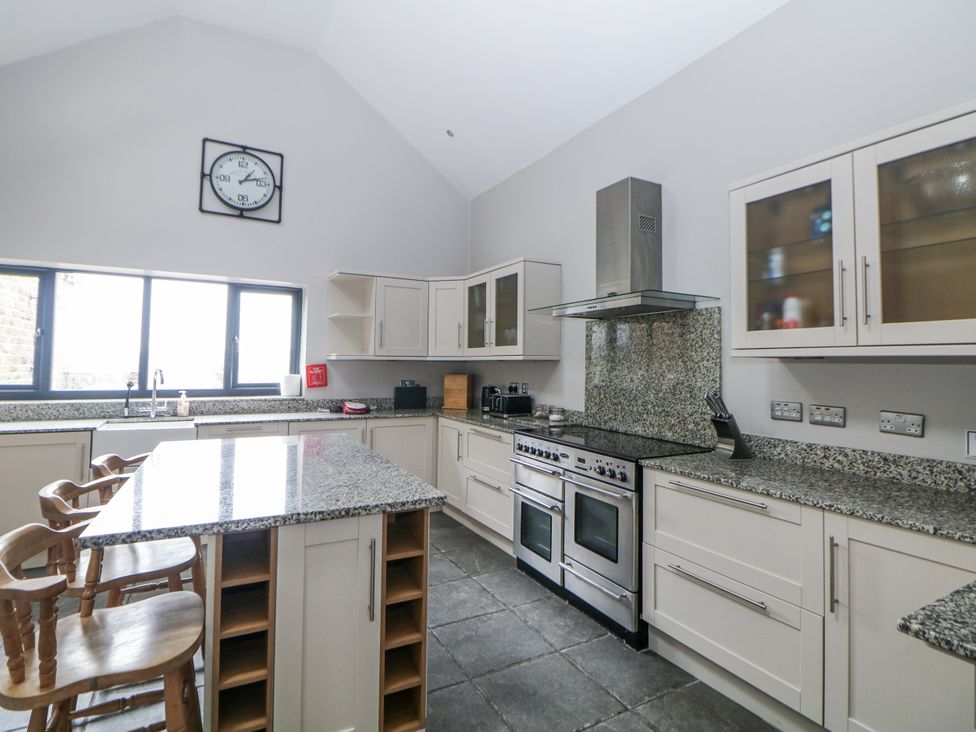 A kitchen with a stove and sink at The Old Robin Hood in Holmesfield near Bakewell