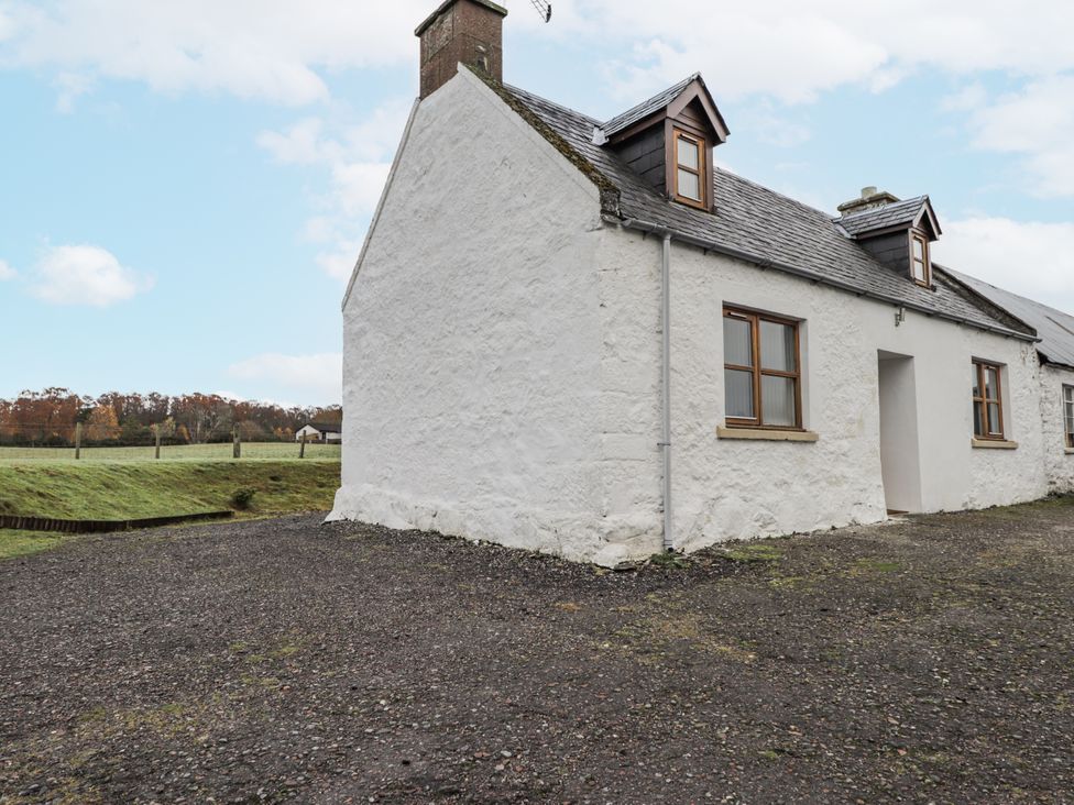 A side view of a house with windows and door at The Croft House in Muir of Ord near Beauly