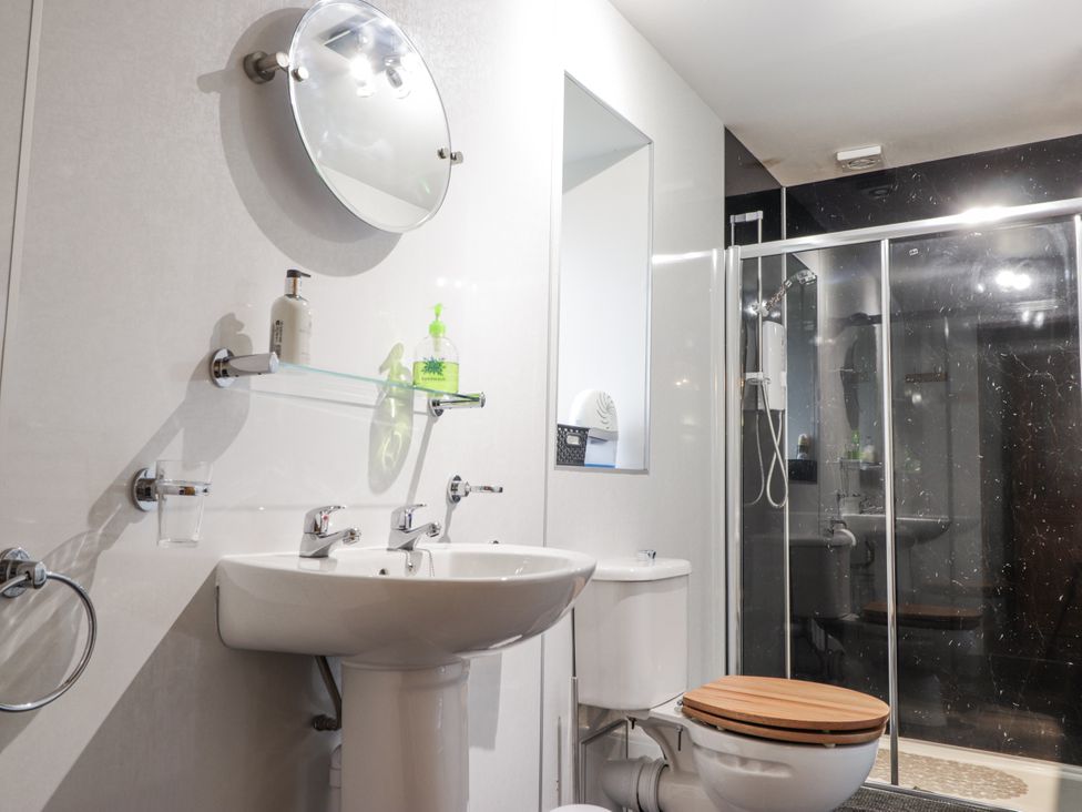 A bathroom with a sink and shower at The Croft House in Muir of Ord near Beauly