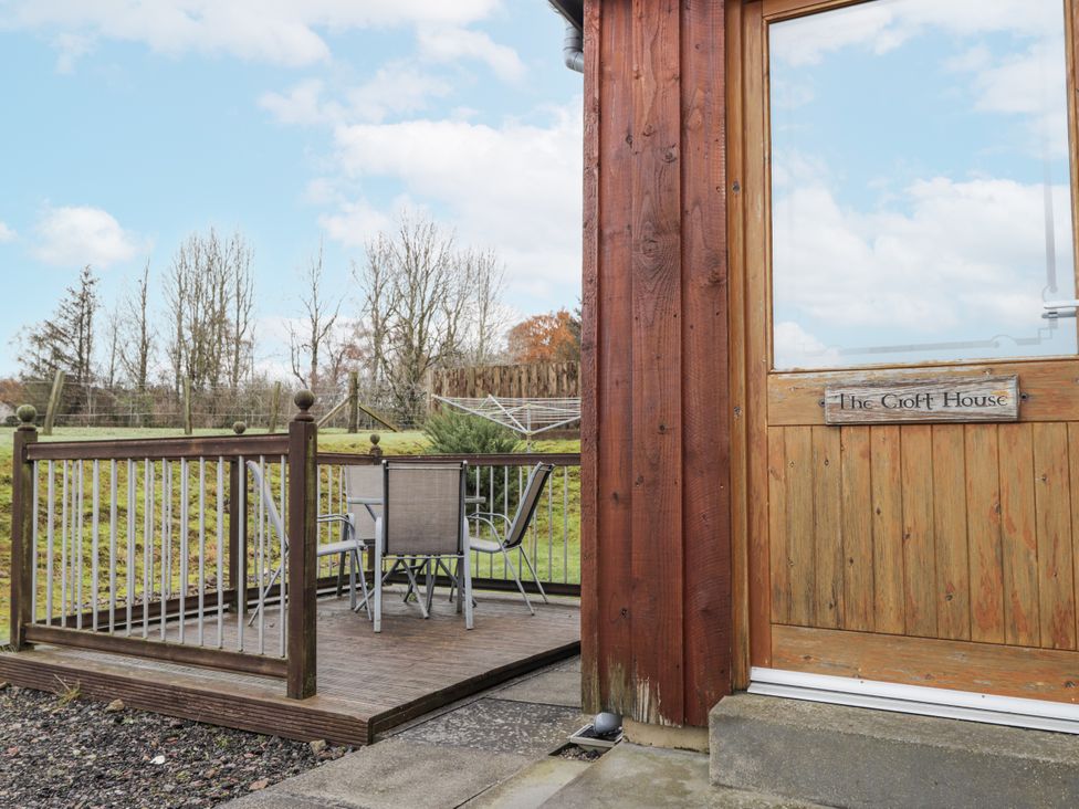 A patio with a table and chairs at The Croft House Muir of Ord near Beauly