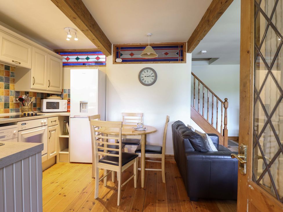 A kitchen with a table and chairs at Stabal Cottage in Dolgellau