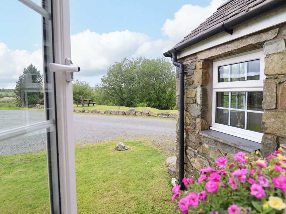 A view from a window showing a garden area at Stabal Cottage in Dolgellau