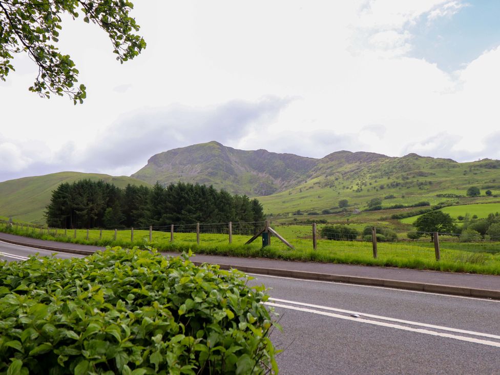 A landscape with mountains and road at Stabal Cottage in Dolgellau