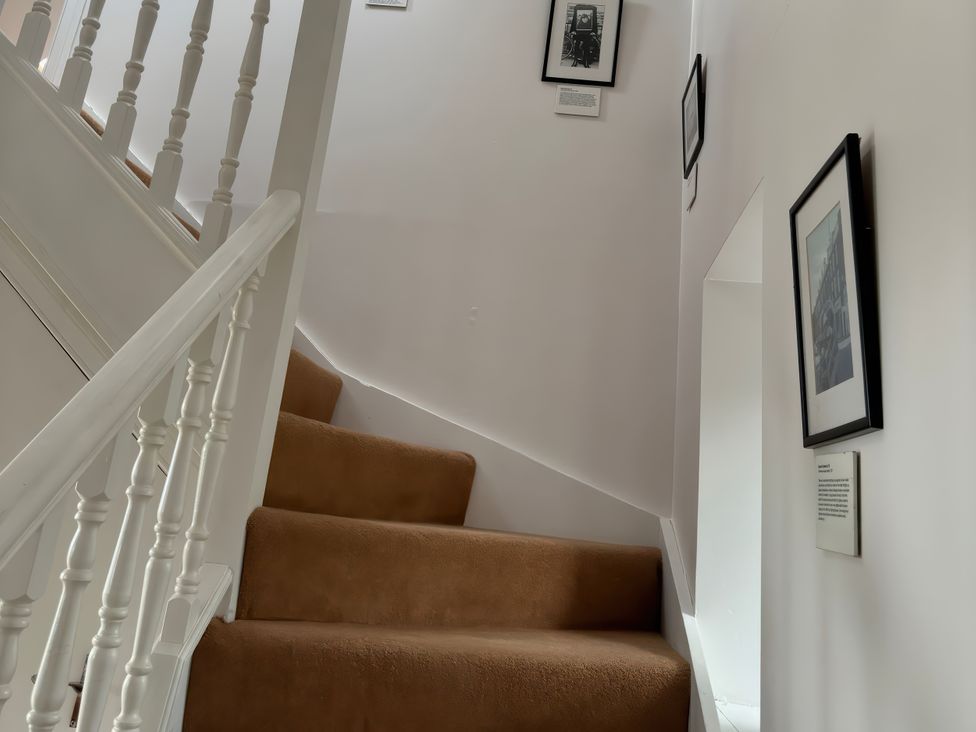 A staircase with pictures on the walls at Solas in Broadford
