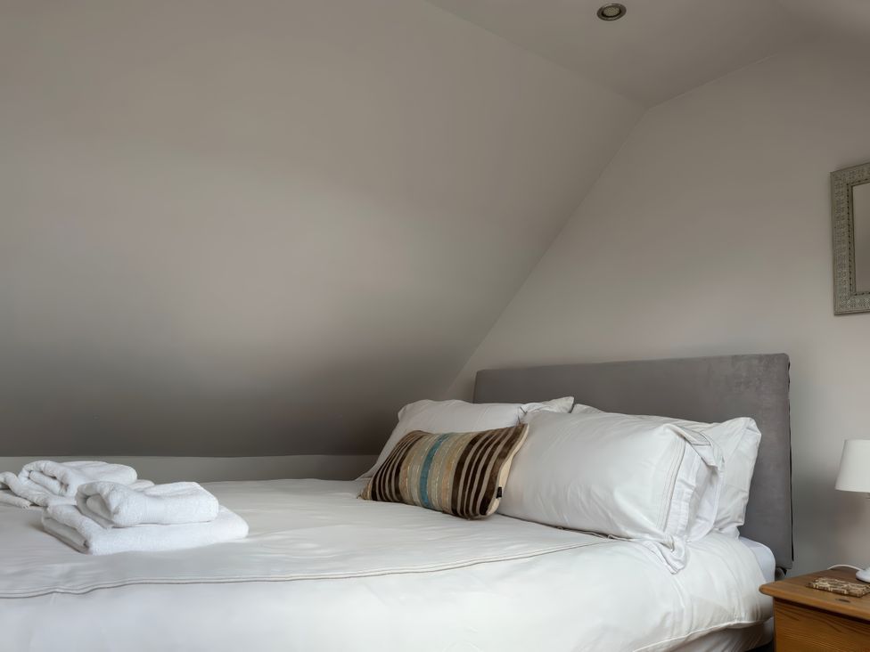 A bedroom with a bed and pillows at Solas in Broadford