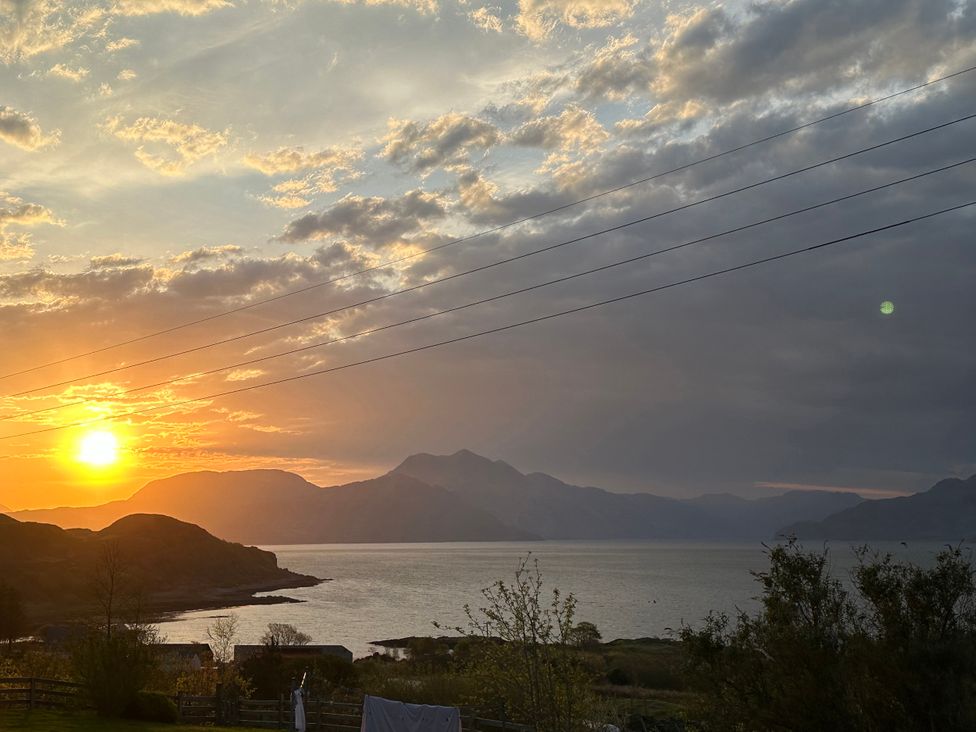 A sunset view over mountains and water at Solas Broadford