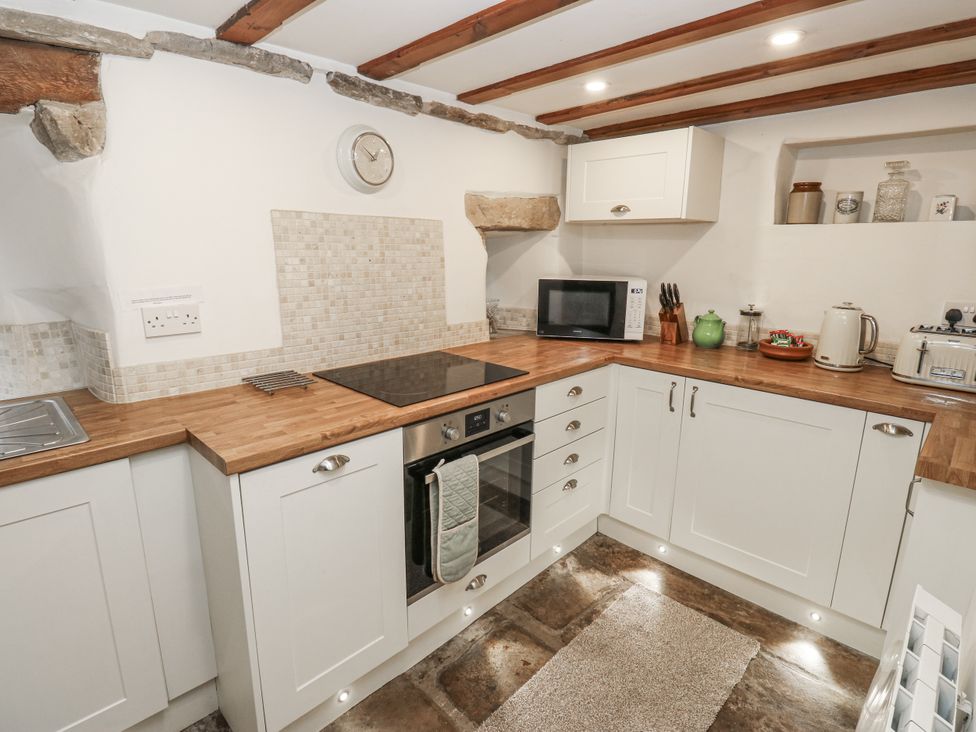A kitchen with a countertop, microwave, and oven at Chamber End Fold in Grassington