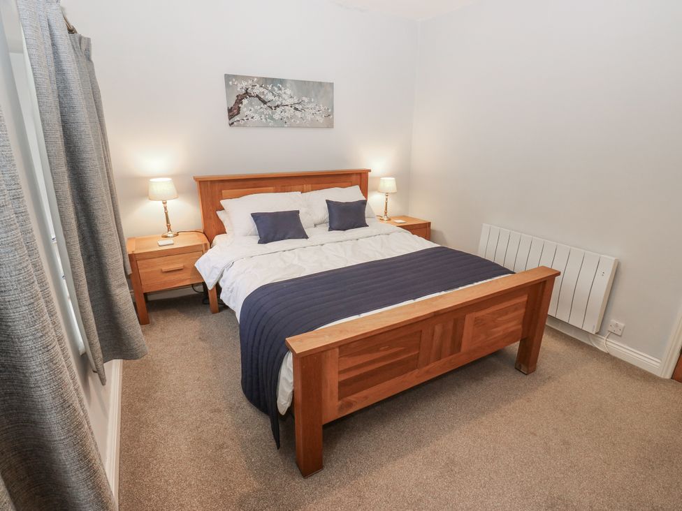 A bedroom with a bed and bedside tables at Chamber End Fold Grassington