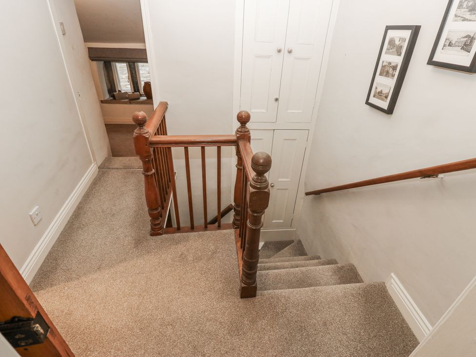 A staircase leading down with a handrail in the hallway at Chamber End Fold Grassington