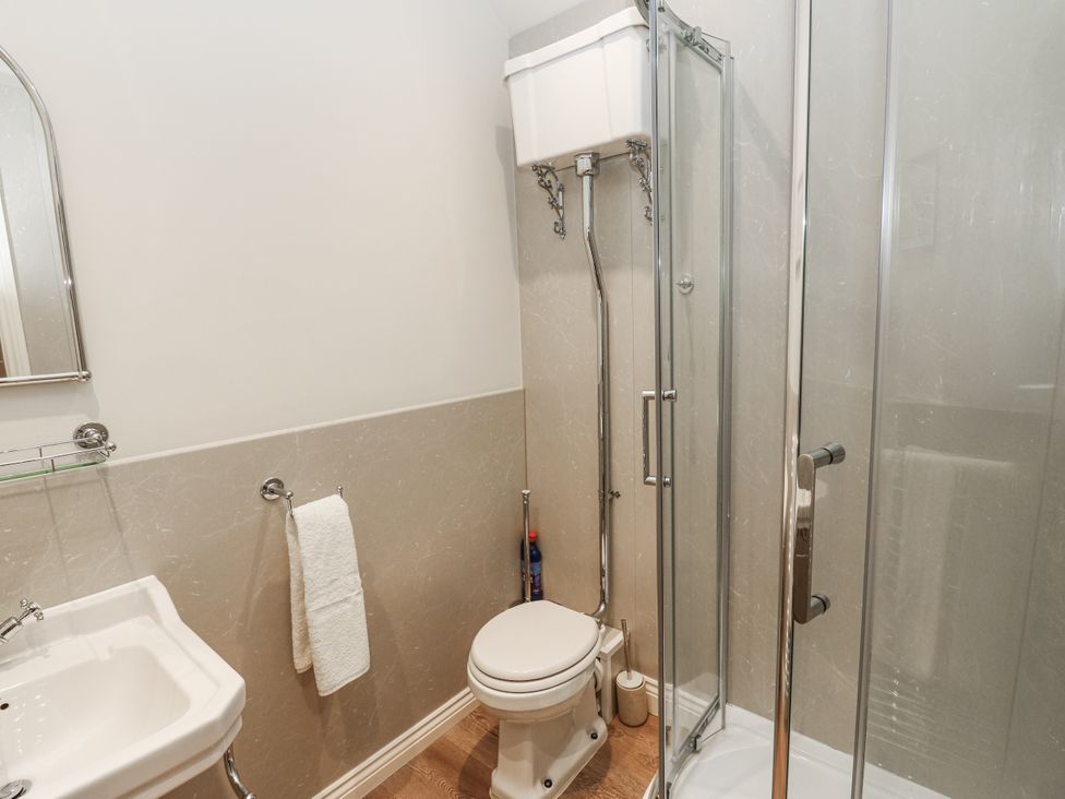 A bathroom with a shower, toilet, and sink at Chamber End Fold in Grassington