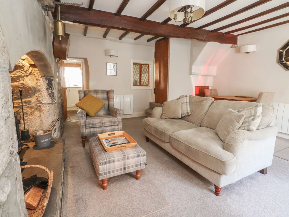 A living room with a sofa and armchair at Chamber End Fold in Grassington