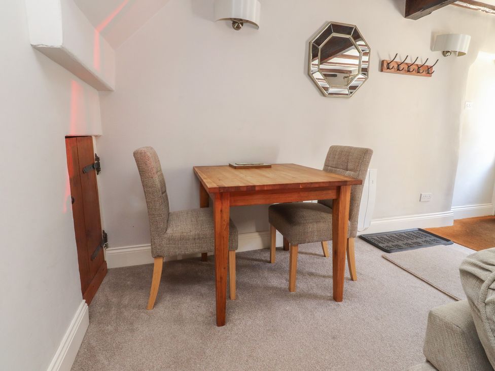 A dining room with a table and chairs at Chamber End Fold Grassington