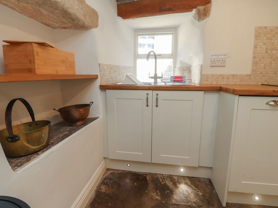 A kitchen with a sink and cabinets at Chamber End Fold Grassington