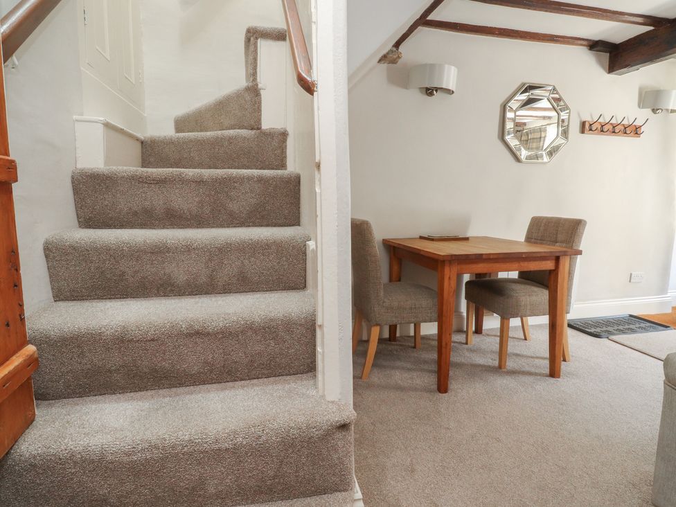 A dining area with a table and chairs at Chamber End Fold Grassington