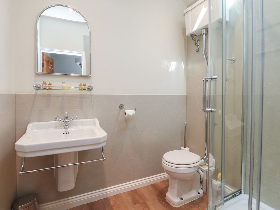 A bathroom with a sink, toilet, and shower at Chamber End Fold in Grassington
