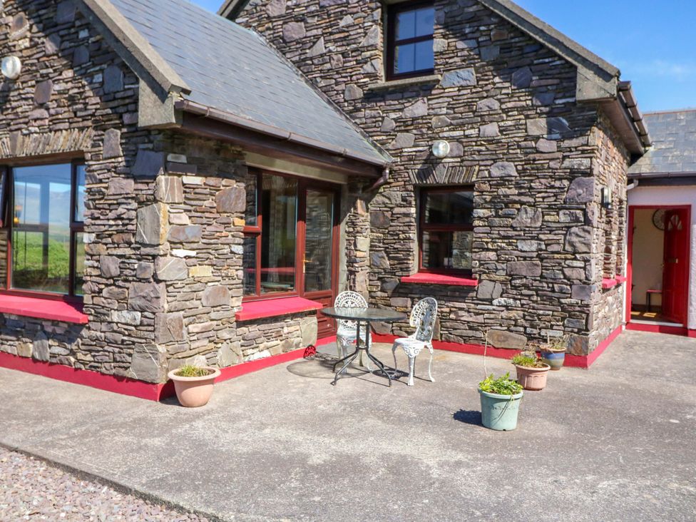 An outdoor setting with a table and chairs at Stone Cottage, Waterville, County Kerry