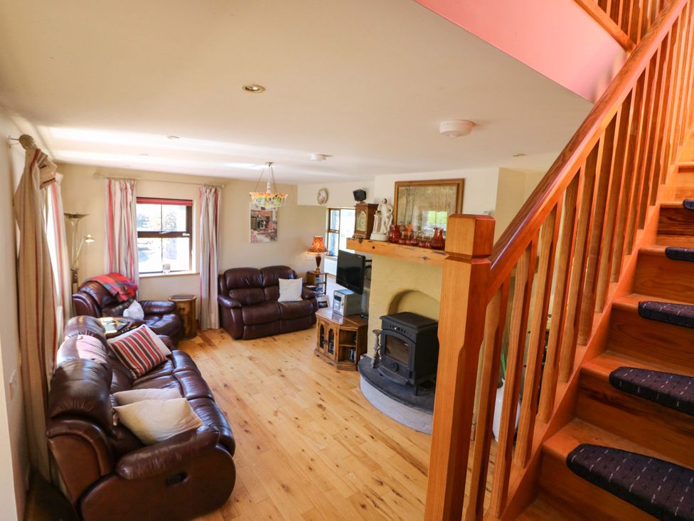 A living room with a sofa and coffee table at Stone Cottage in Waterville, County Kerry
