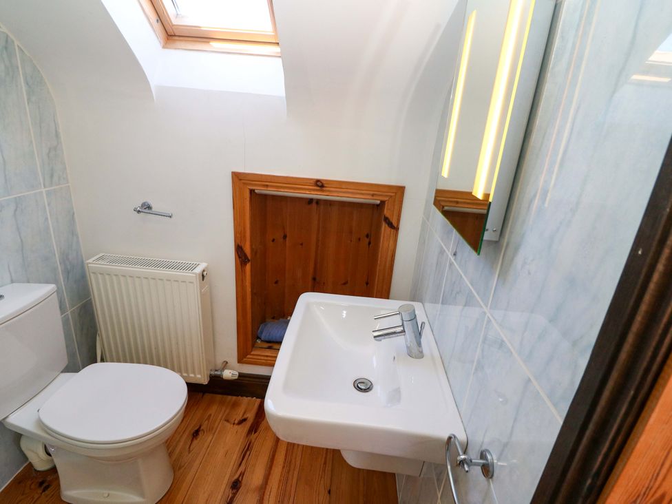 A bathroom with a sink and toilet at Stone Cottage Waterville, County Kerry