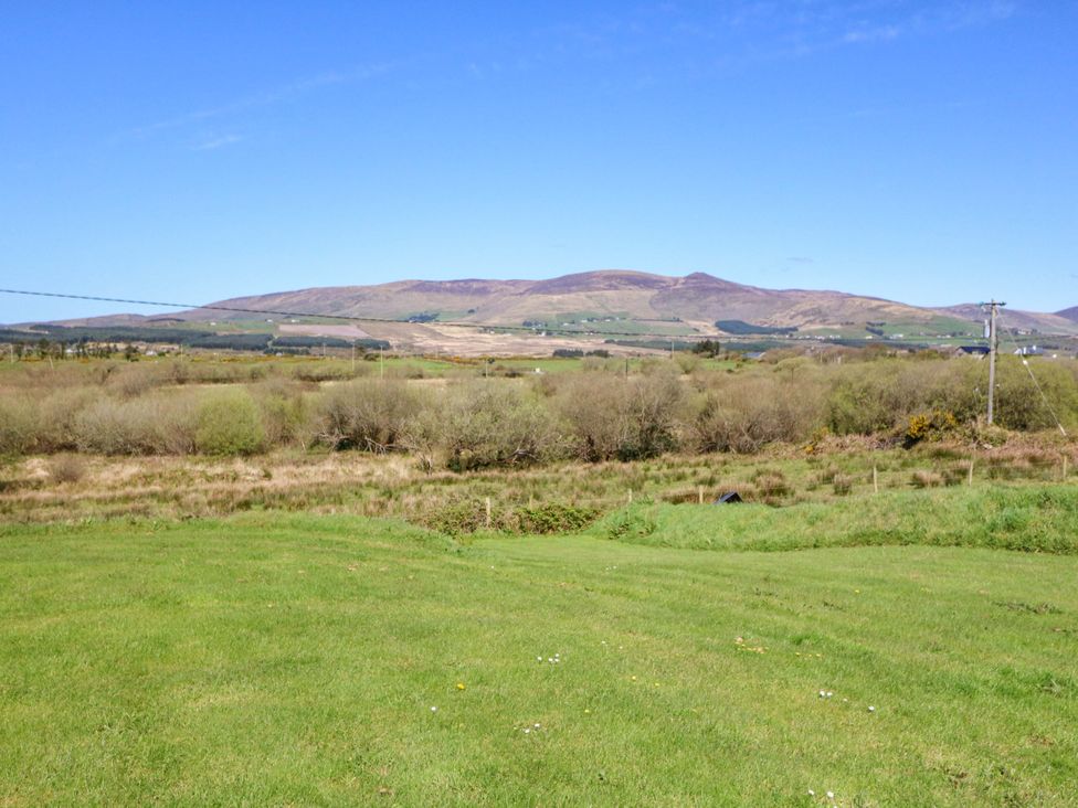 A landscape view of mountains and fields at Stone Cottage in Waterville, County Kerry