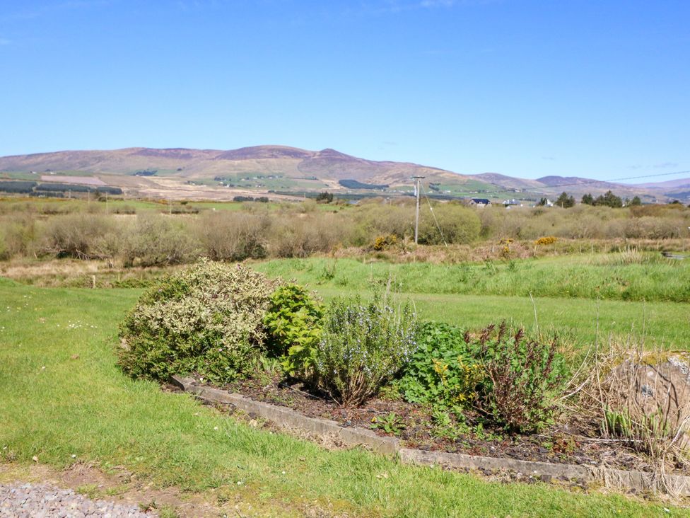 A landscape with shrubs and mountains in the background at Stone Cottage, Waterville, County Kerry