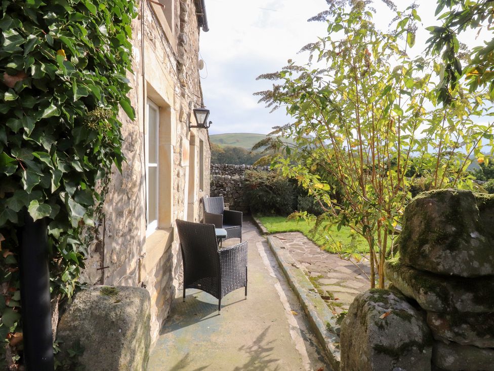 A garden with a pathway and chairs at Sandywood in Burnsall near Grassington