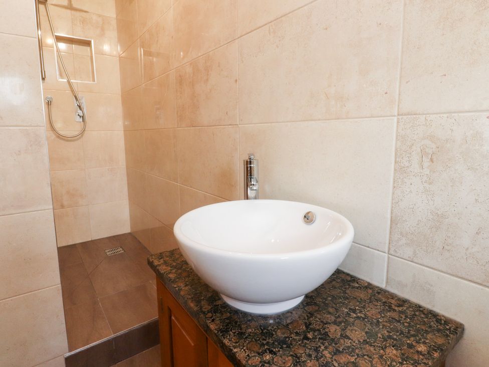 A bathroom with a shower and a sink at Sandywood in Burnsall near Grassington