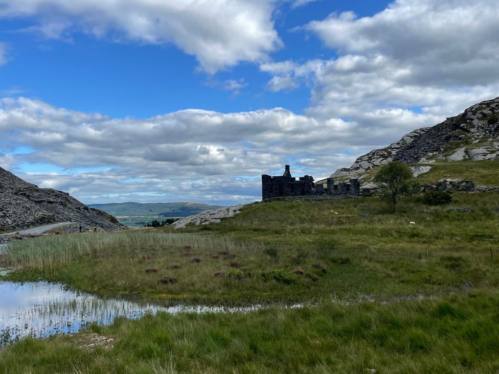 A view of a ruined building in a grassy landscape at Tafarn Trip, Tan Y Bwlch, Maentwrog