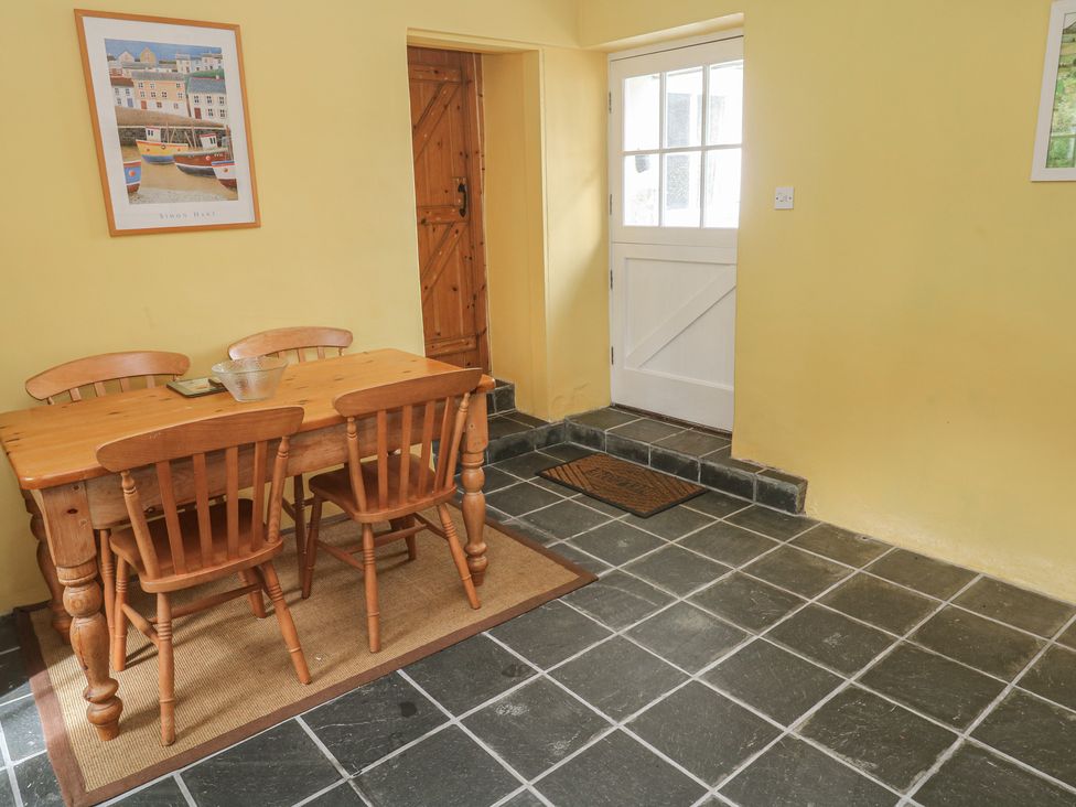 A dining room with a table and chairs at Swallows, St Keverne, Lizard Peninsula