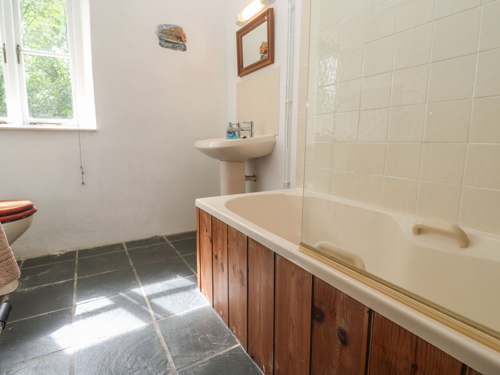A bathroom with a bathtub and sink at Swallows St Keverne, Lizard Peninsula