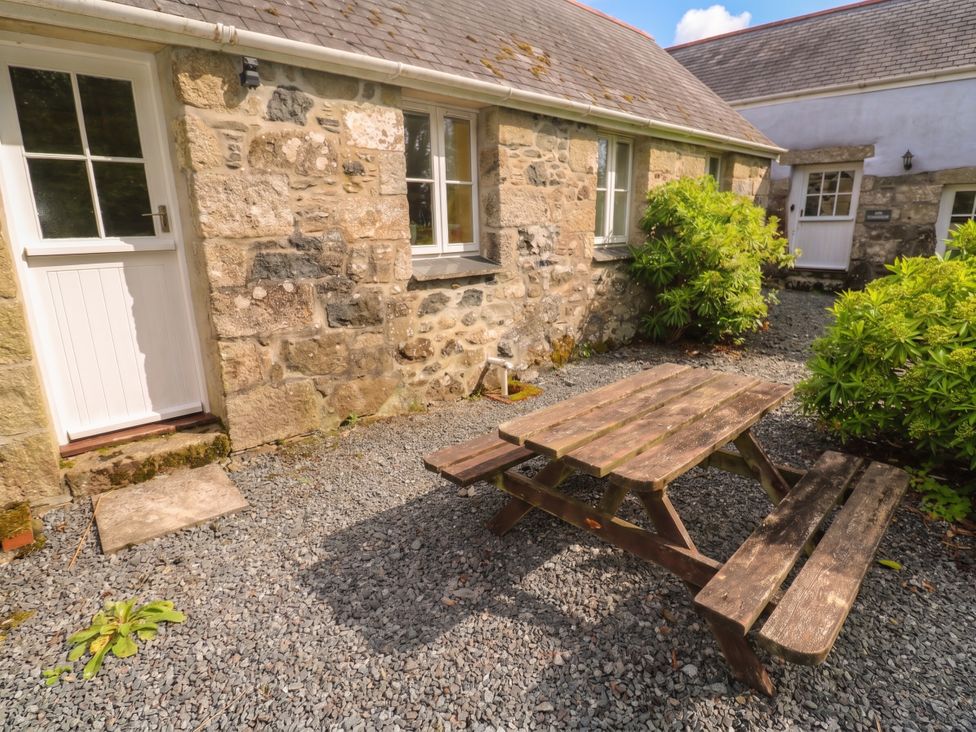 An outdoor area with a picnic table and plants at Swallows, St Keverne, Lizard Peninsula