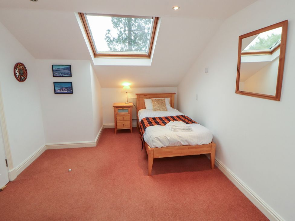 A bedroom with a single bed and side table at Winster Fields in Cartmel Fell near Windermere