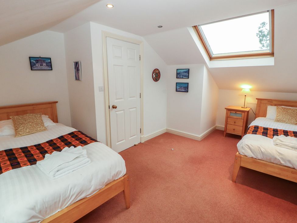 A bedroom with two beds and a skylight at Winster Fields Cartmel Fell near Windermere