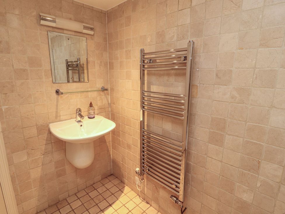A bathroom with a sink and towel rail at Winster Fields Cartmel Fell near Windermere