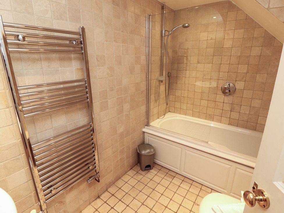 A bathroom featuring a bath tub and shower at Winster Fields, Cartmel Fell near Windermere