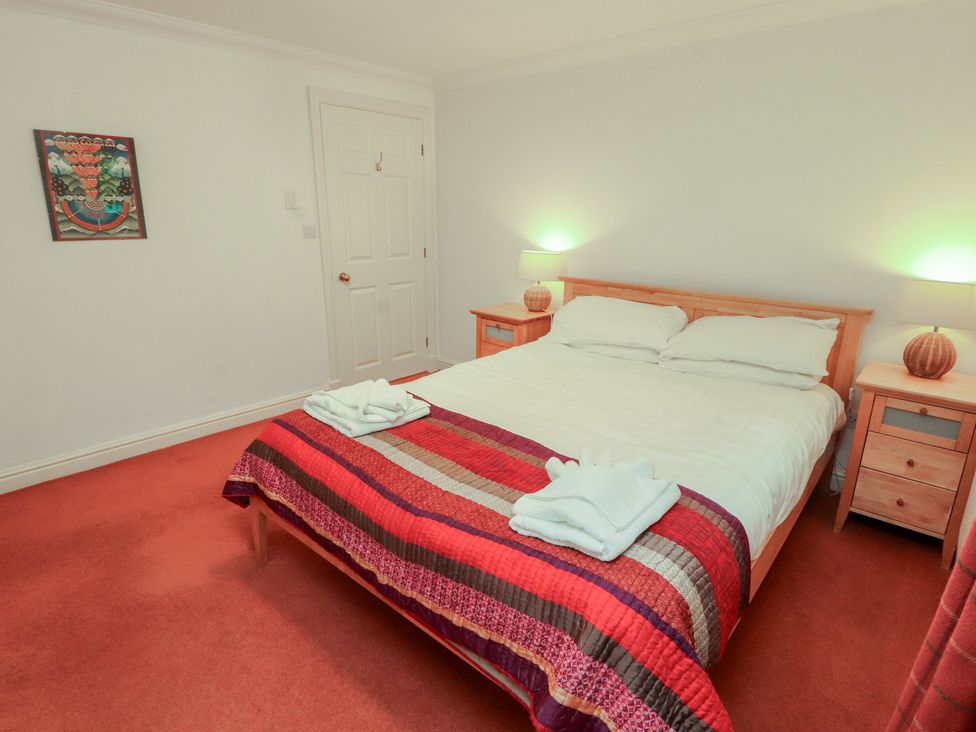 A bedroom with a bed and nightstands at Winster Fields Cartmel Fell near Windermere