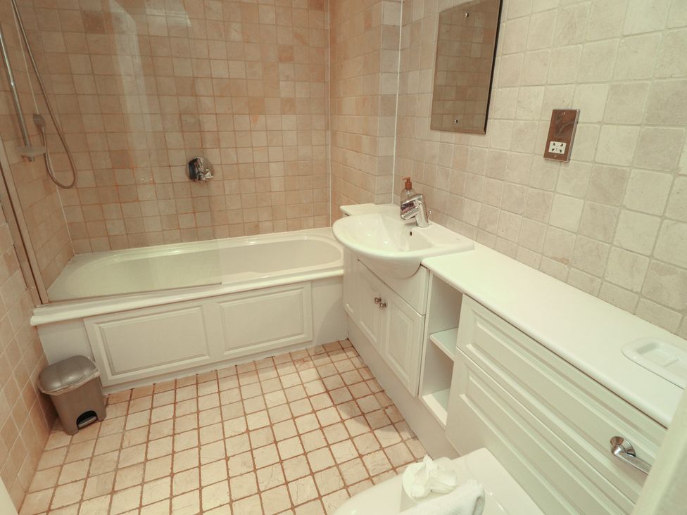 A bathroom with bathtub, sink, and toilet at Winster Fields in Cartmel Fell near Windermere