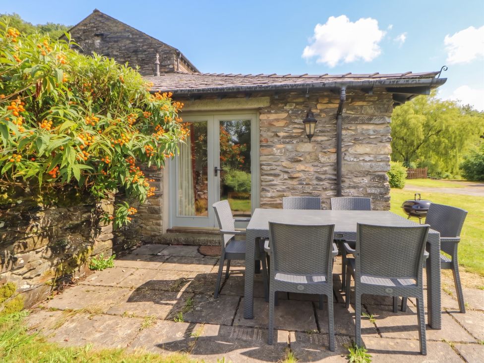 A patio with a table and chairs at Winster Fields Cartmel Fell near Windermere