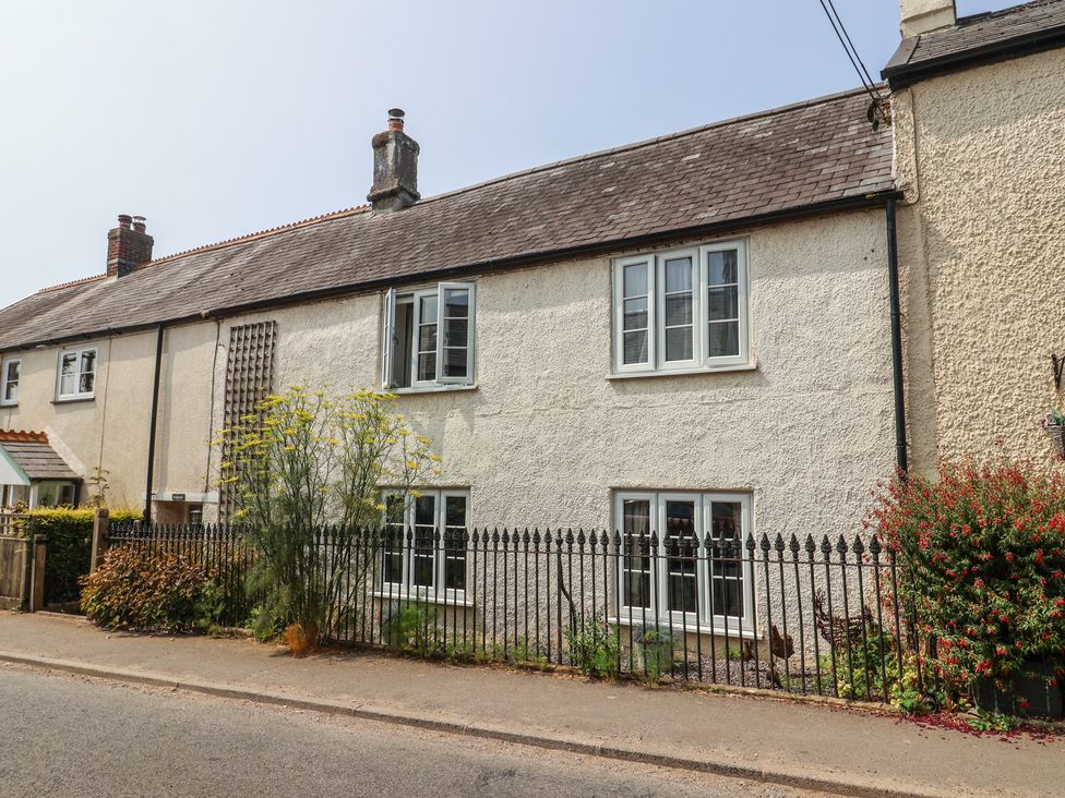 A house with windows and plants in front at Church Farmhouse in Winsham