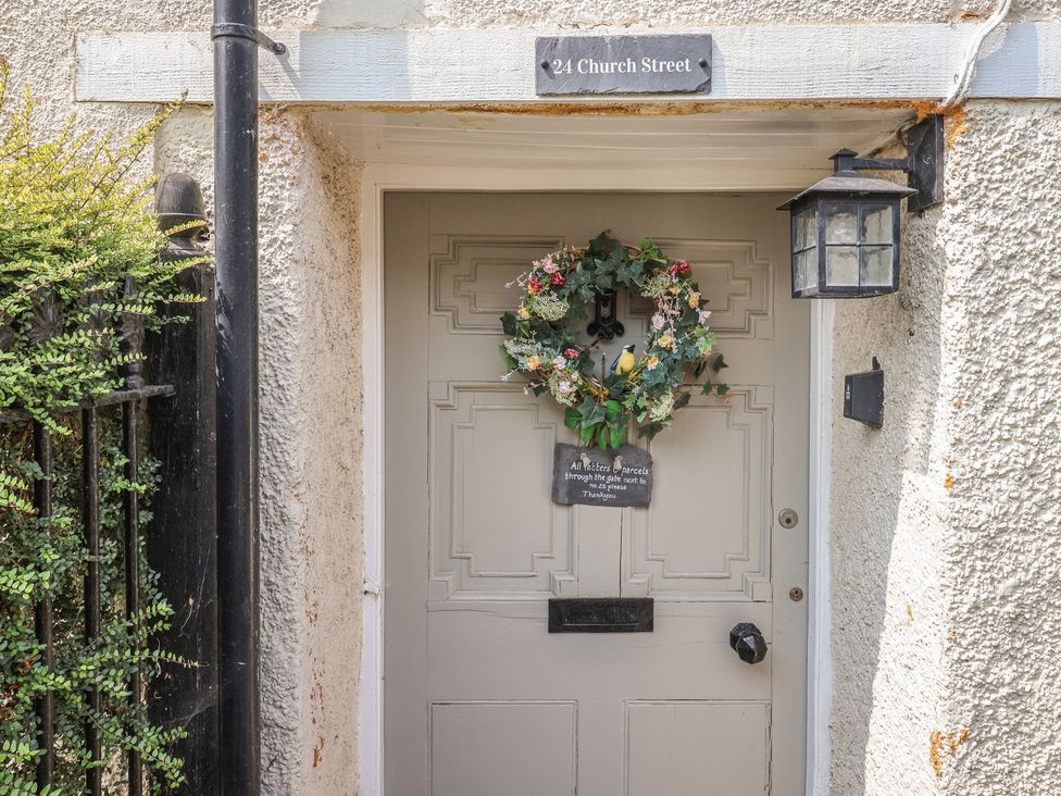 An entryway with a door and wreath at 24 Church Street in Winsham