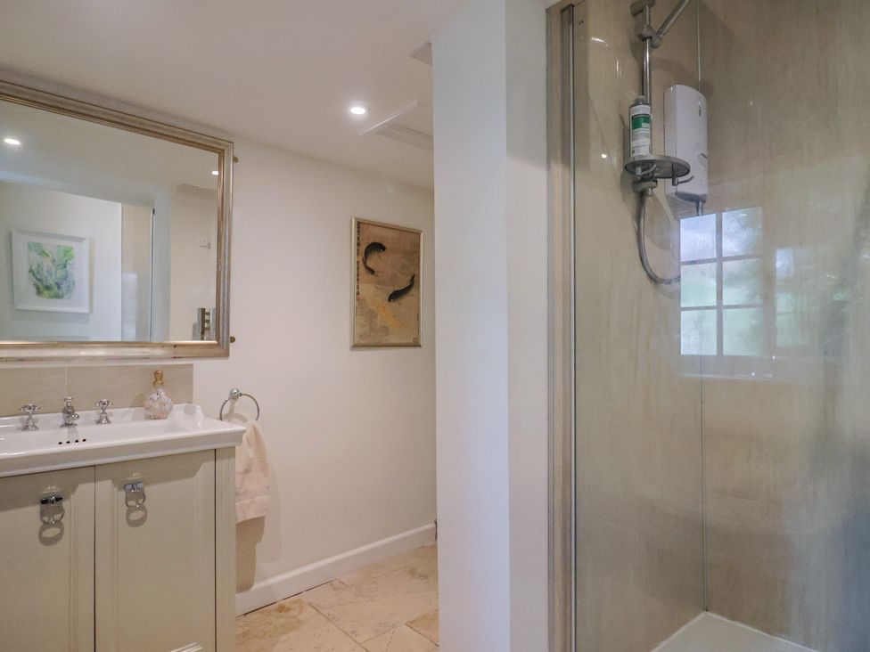 A bathroom with a sink and shower at Church Farmhouse in Winsham