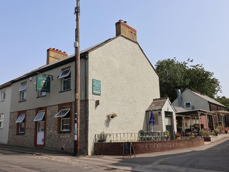 A pub with outdoor seating at The Bell in Winsham
