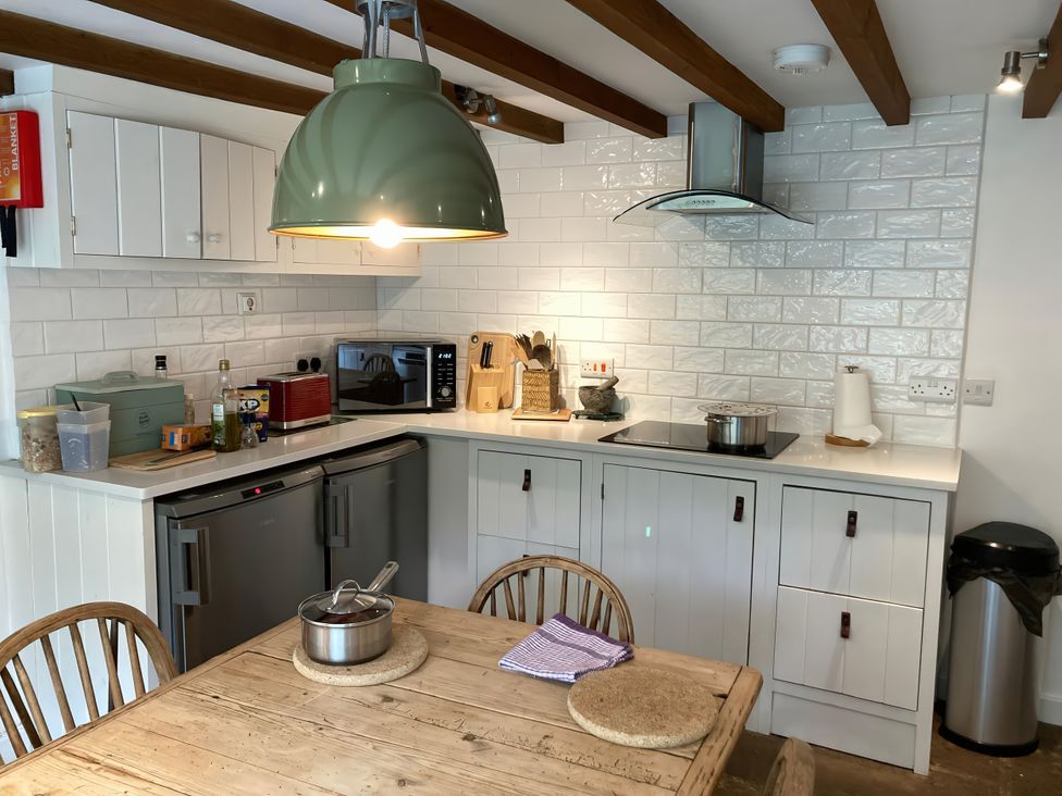 A kitchen with a table and chairs at The Old Post Office in Marrick near Reeth