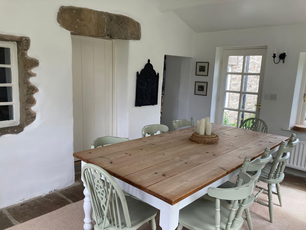 A dining room with a table and chairs at The Old Post Office in Marrick near Reeth