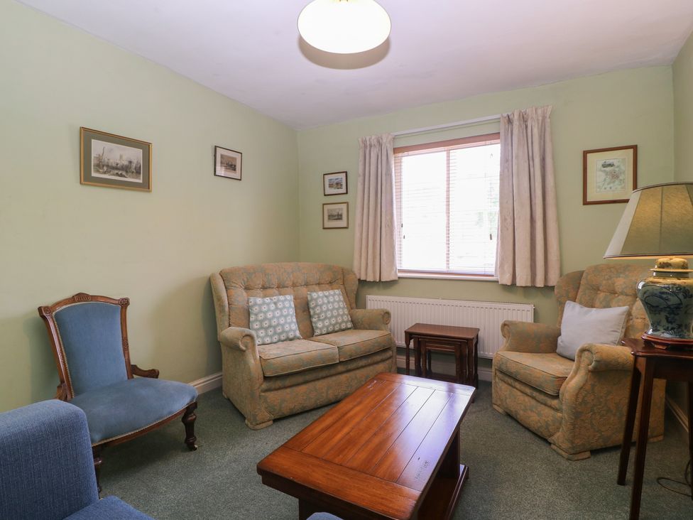 A living room with a sofa and armchairs at The Lock House in Gloucester