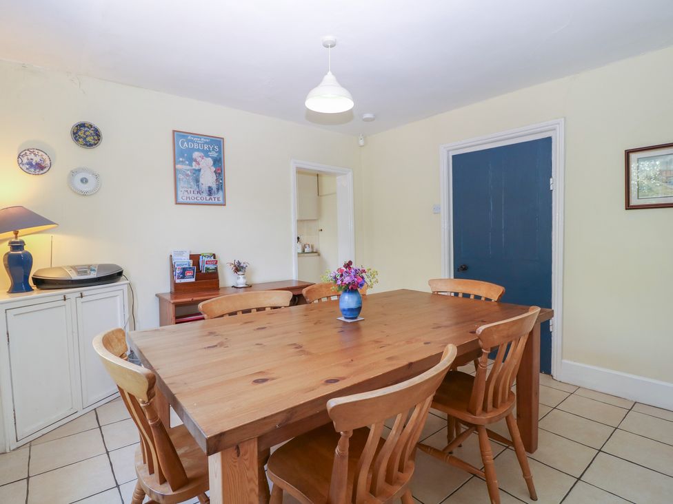 A dining room with a wooden table and chairs at The Lock House in Gloucester