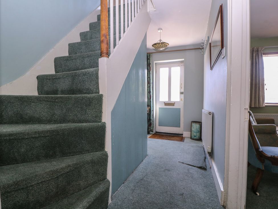 A hallway with staircase and door at The Lock House in Gloucester