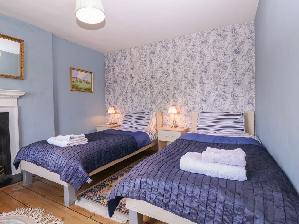 A bedroom with two beds and a mirror at The Lock House in Gloucester