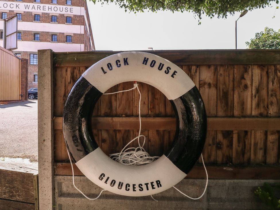 A lifebuoy mounted on a wooden fence at The Lock House in Gloucester