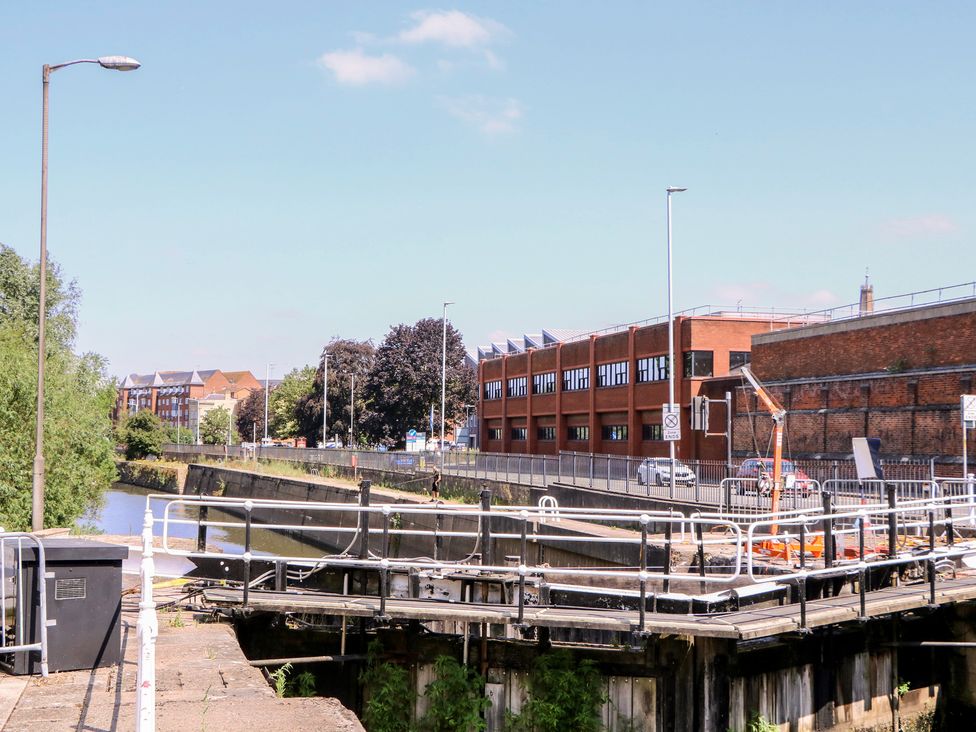A canal with buildings and a streetlight in Gloucester