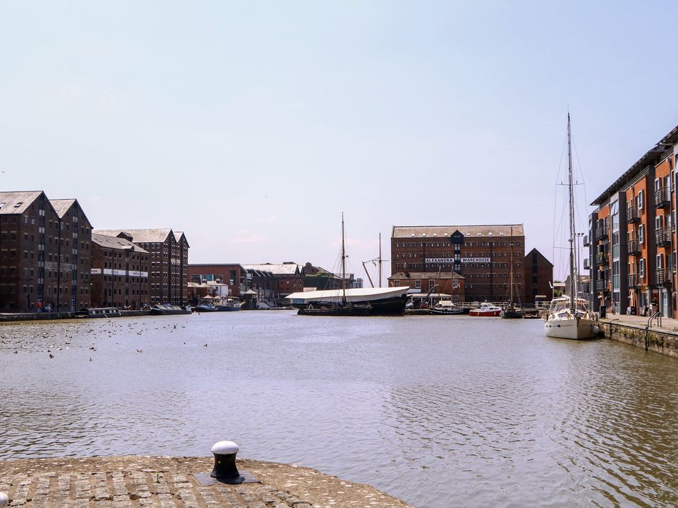A waterfront view with buildings and boats at The Lock House in Gloucester